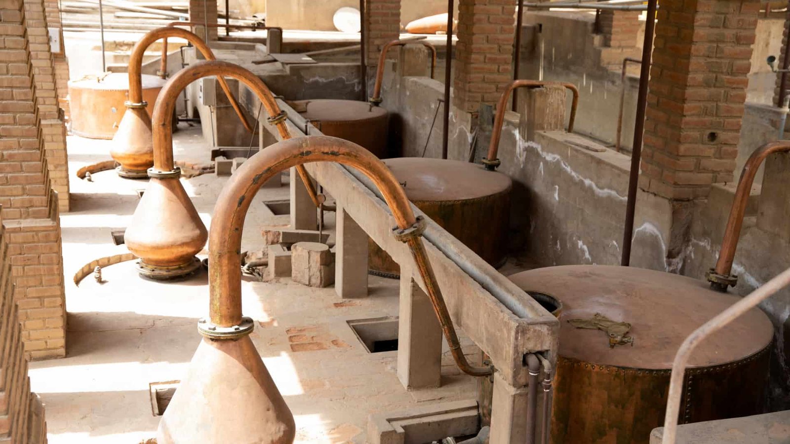 Instalaciones de bodega de Pisco con alambiques y estructuras de piedra.